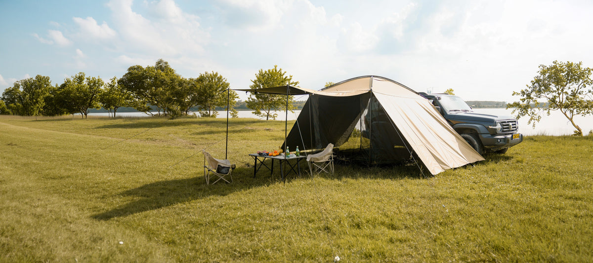 AT200 outdoor shelter beside a vehicle at a campsite